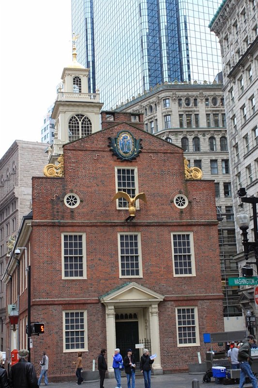 IMG_3425.jpg - The Old State House with its State Street gable adorned by a brightly gilded lion and unicorn, symbols of British imperial power.  Queen Elizabeth II visited here on July 4, 1976 and stood on the balcony from which the Declaration of Independence was first read in public and overlooks the site of the Boston Massacre.
